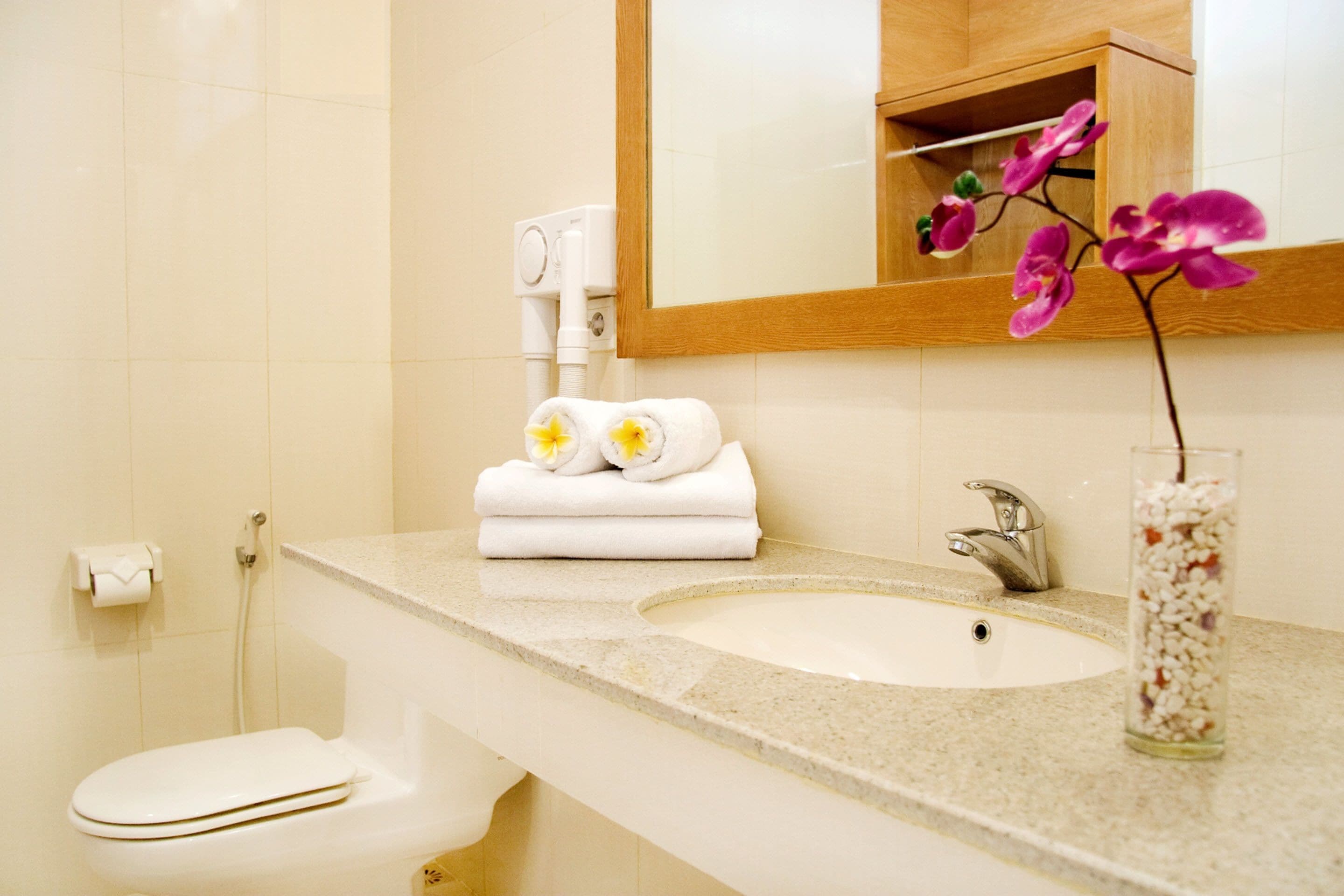 hair dryer, slippers, bidet, towels