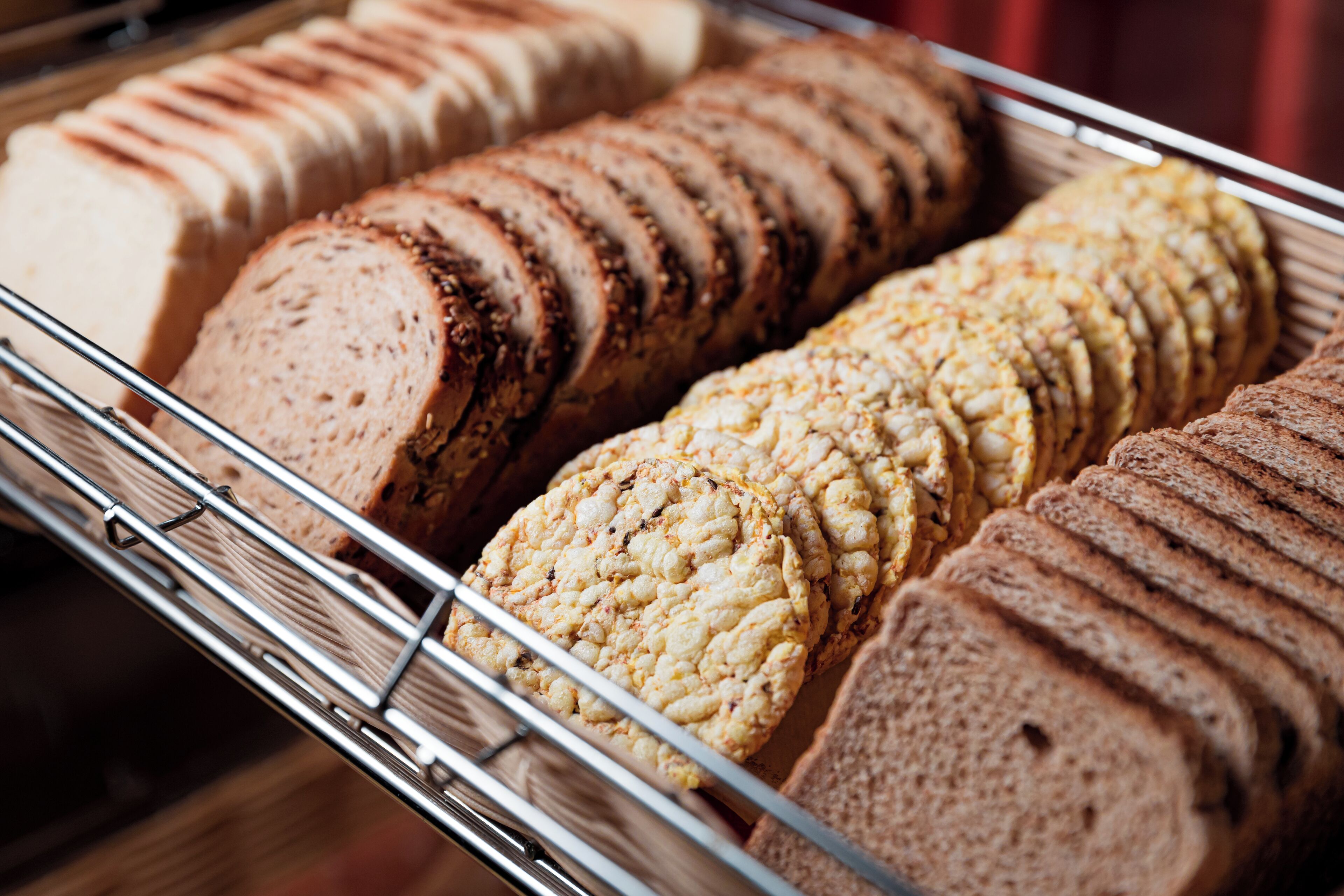 A display of sliced bread in a metal rack.