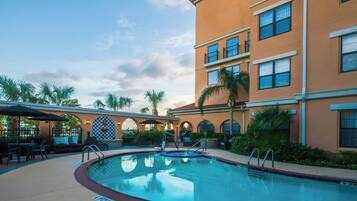 Outdoor pool, open 7:00 AM to 10:00 PM, pool umbrellas, sun loungers