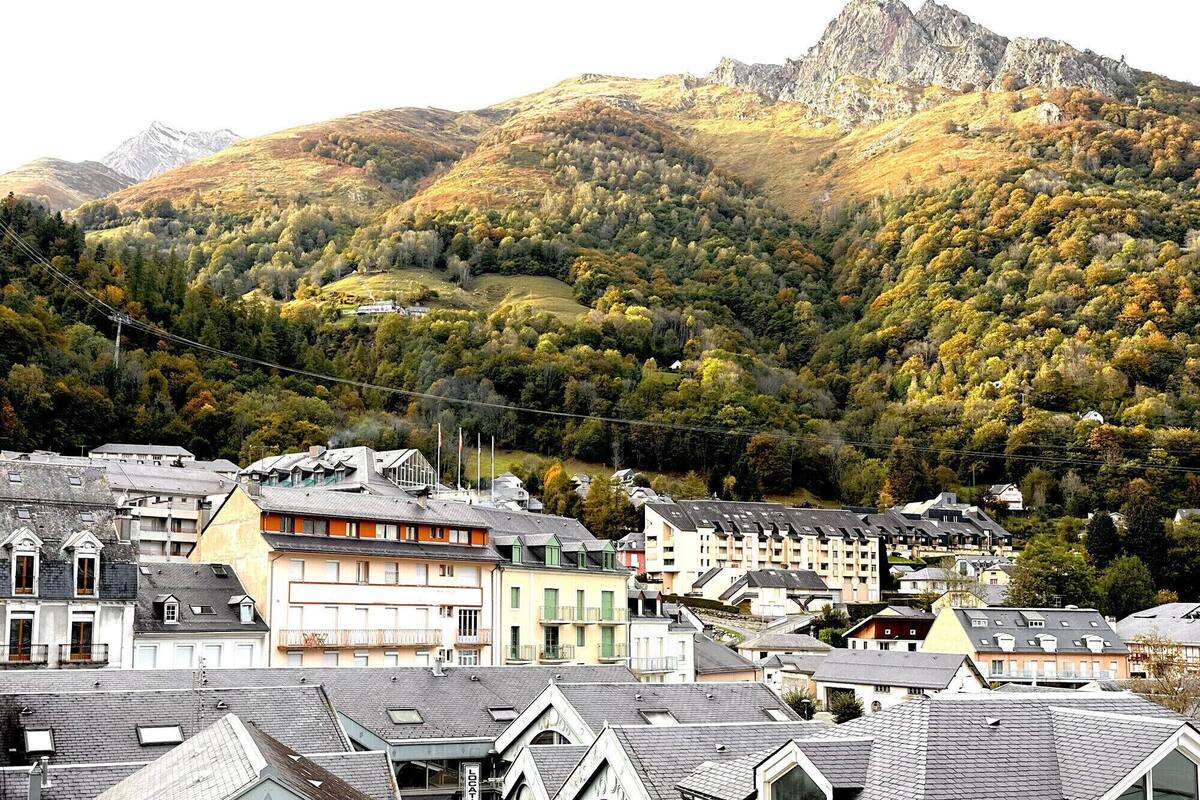 A town with traditional European architecture, including multi-story buildings with sloped roofs and balconies.