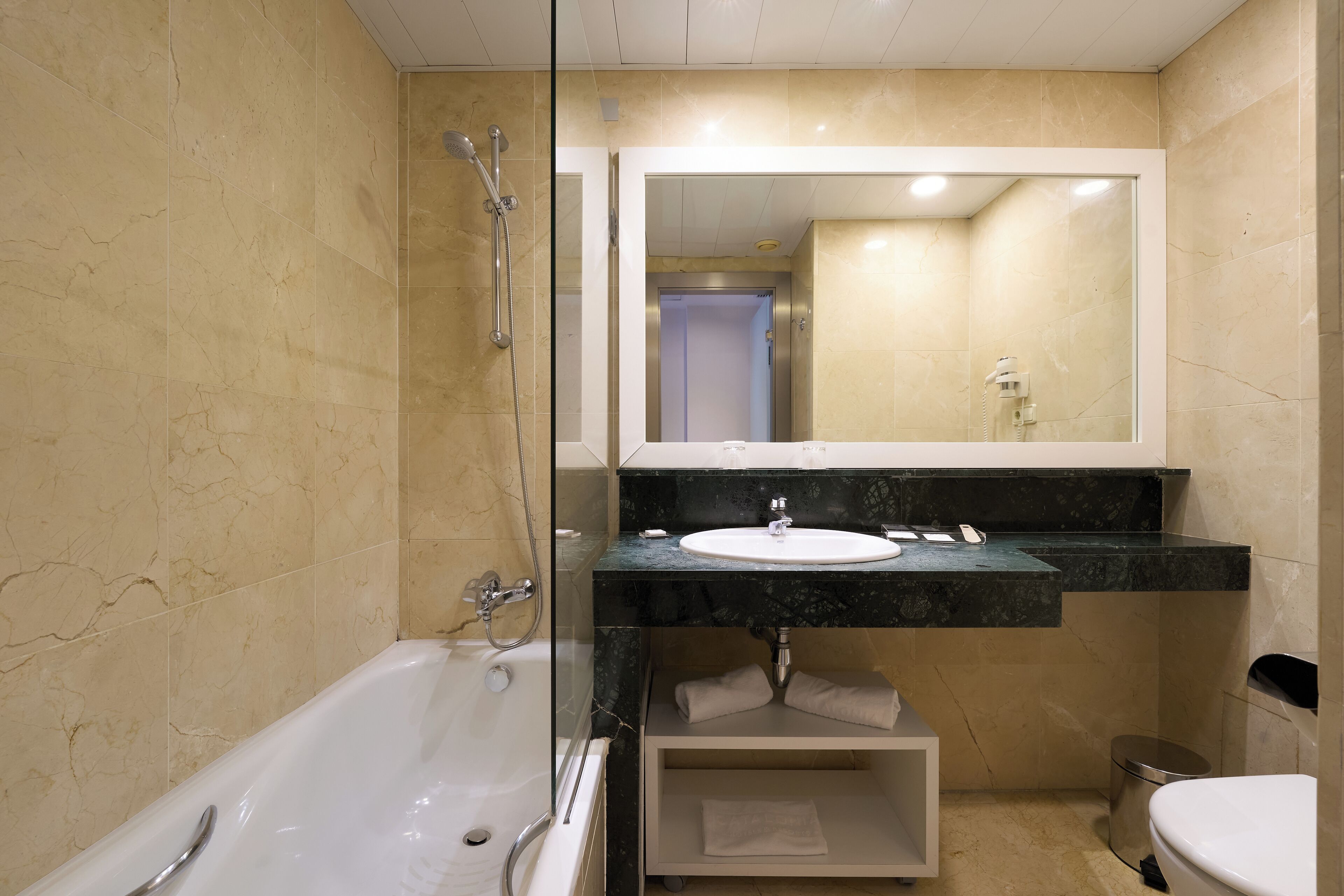 A bathroom with a bathtub, a sink, and a toilet.