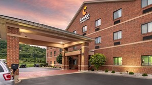 A Comfort Inn & Suites building with a brick facade, multiple windows, and a covered entrance area. - Comfort Inn & Suites Lawrenceburg (Lawrenceburg)