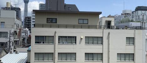 A multi-story building with a flat roof and several windows.