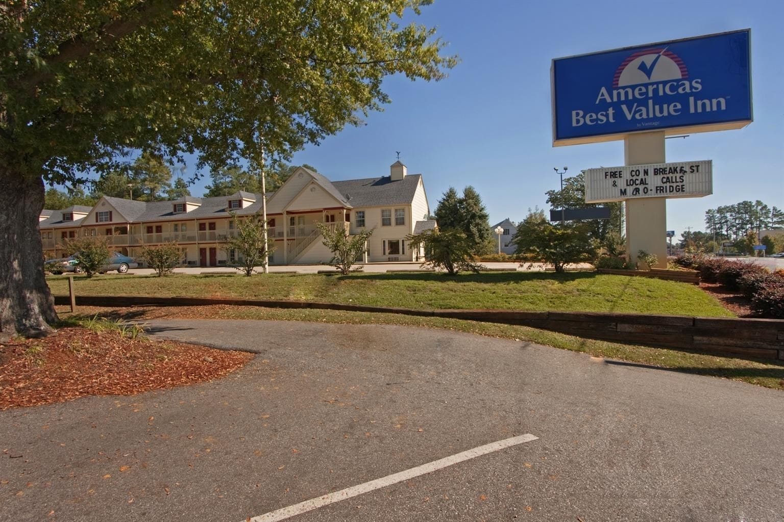 A Best Value Inn sign with a clear view of the building's exterior, including multiple-story structures with a traditional architectural style.