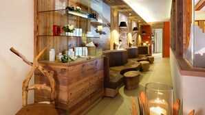 A reception area with a wooden reception desk, seating area, and a glass display cabinet.