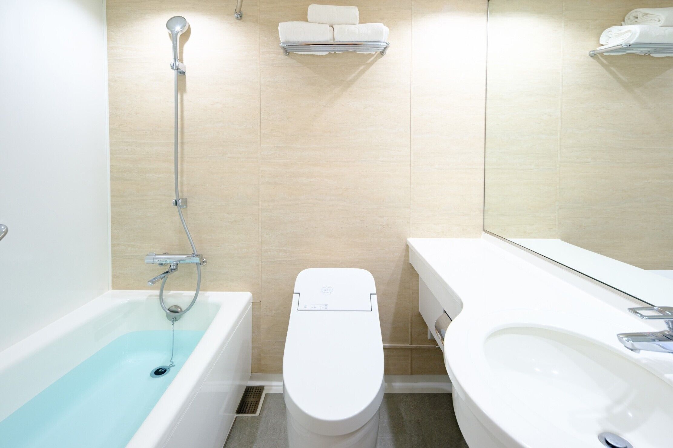 A modern bathroom with a bathtub, toilet, and sink.