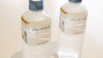 Two bottles of 'One Harmony' natural mineral water.