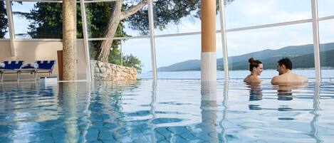 An indoor swimming pool with clear views of the surrounding landscape.