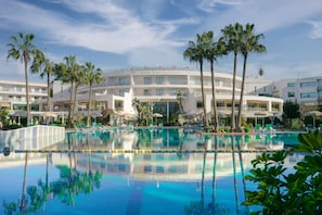 A hotel with a large pool surrounded by palm trees and lounge chairs. - AGADIR BEACH CLUB HOTEL (Agadir)