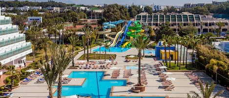 A resort with multiple swimming pools, a water park, and a variety of lounge areas.