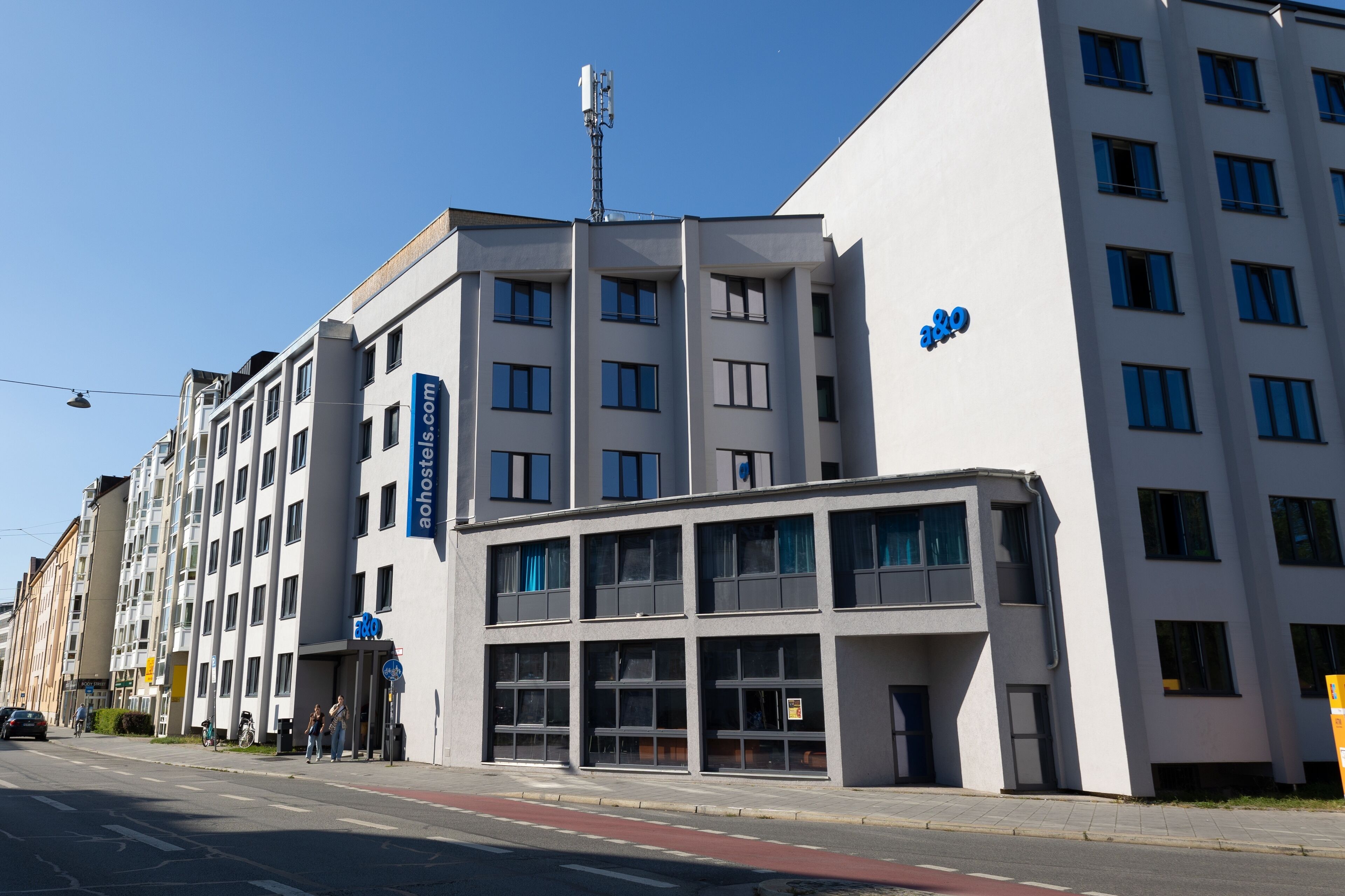 Un edificio moderno con varios pisos, ventanas amplias y un toldo destacado.
