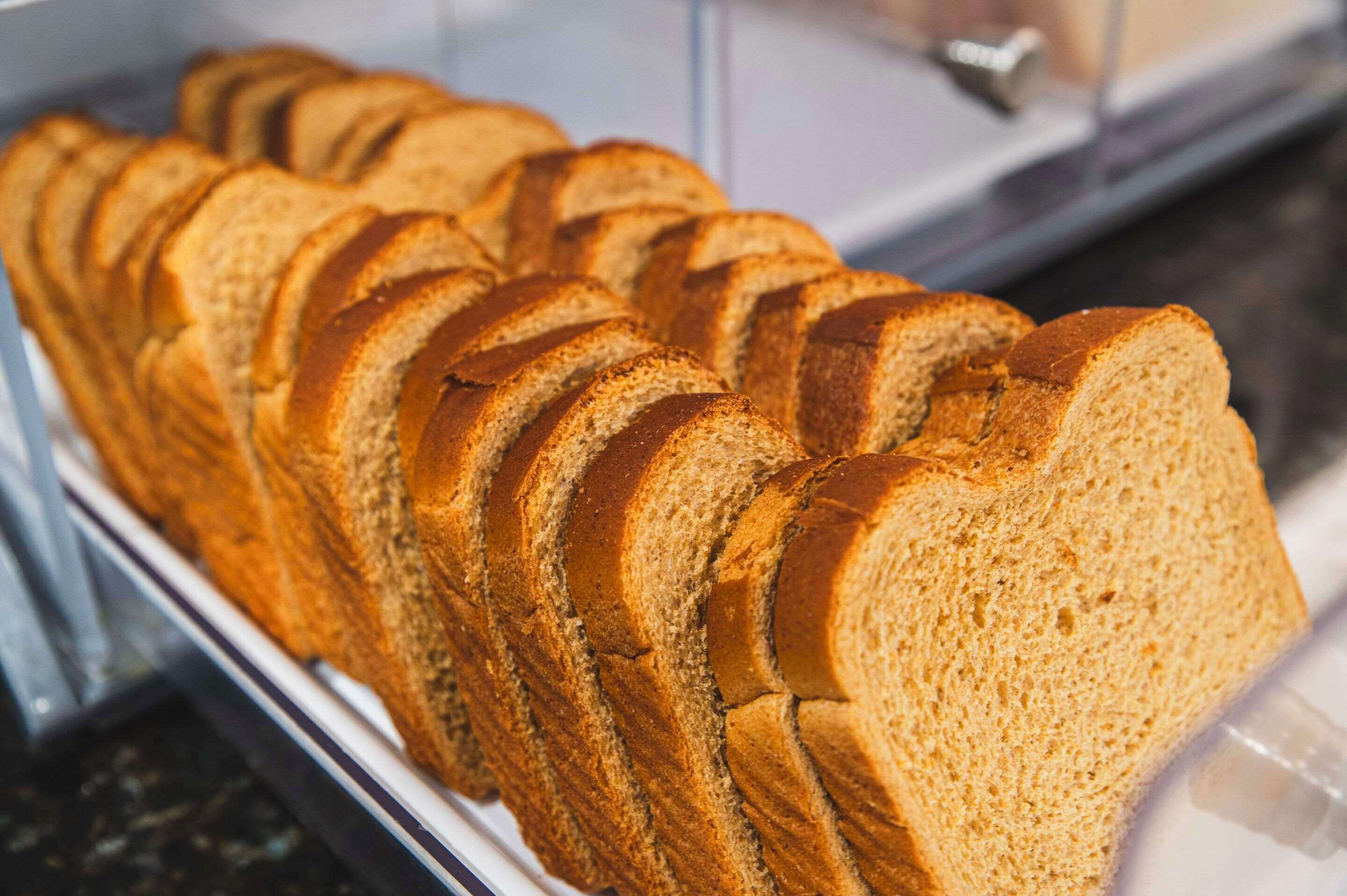 A loaf of sliced bread in a bakery display case.