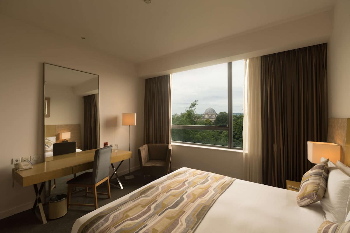 superior room, 1 king bed (tree line view) | in-room safe, desk, iron/ironing board, bed sheets
