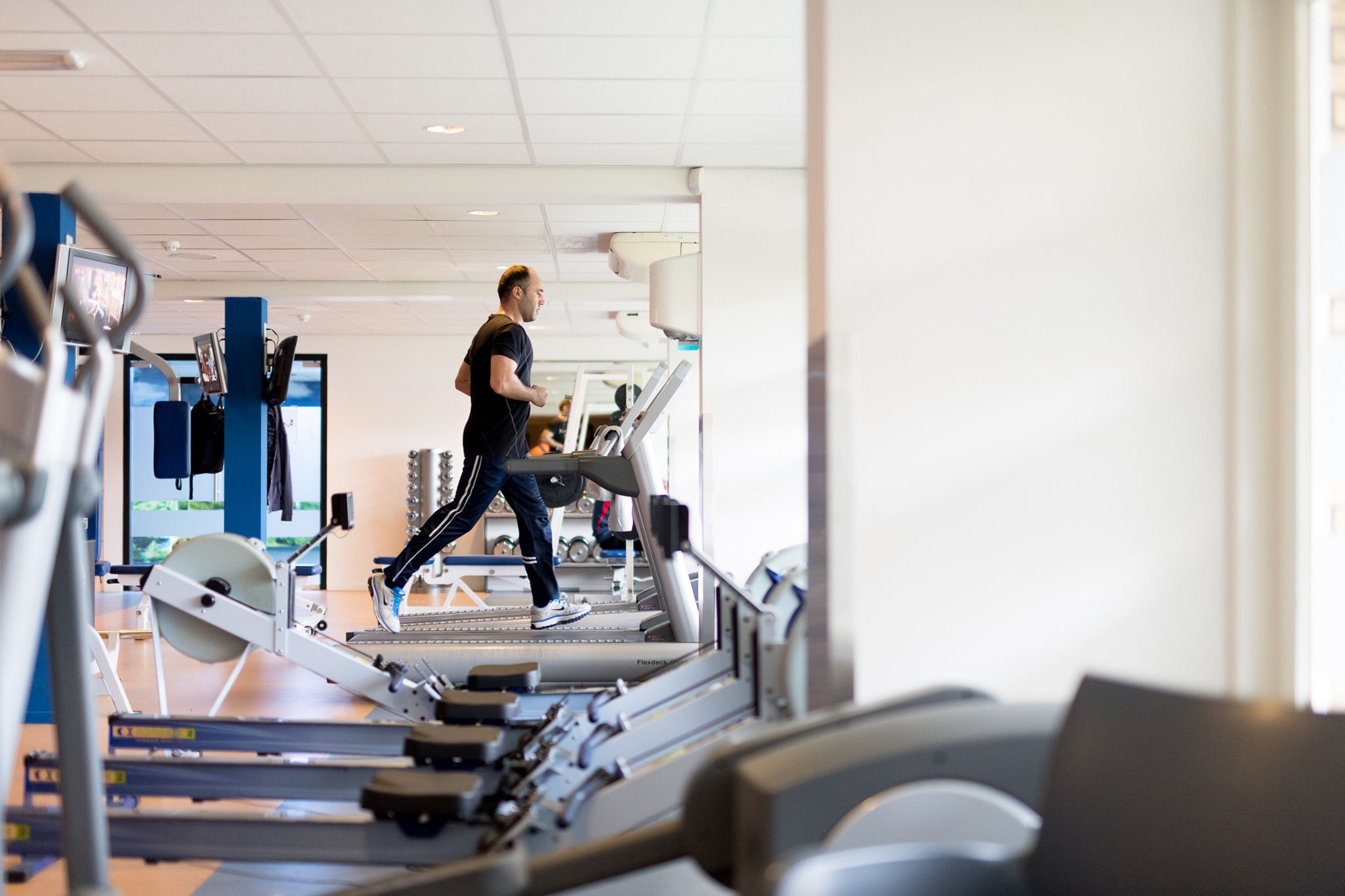 A gym with treadmills and exercise equipment.