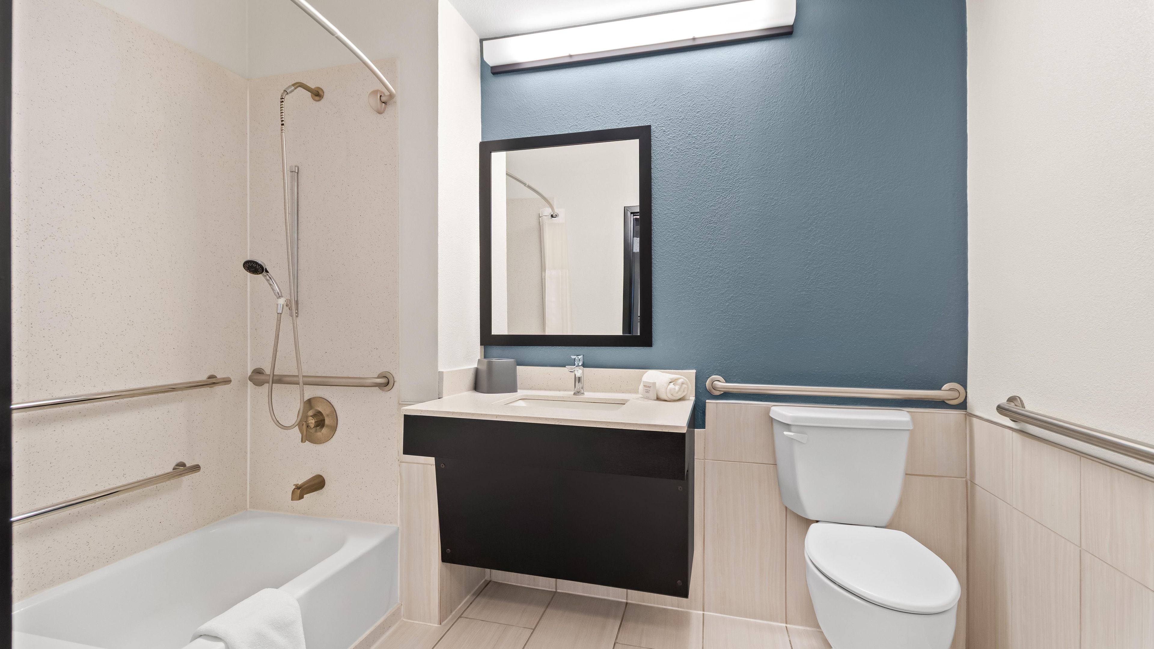A bathroom with a bathtub, a toilet, a sink, and a shower.