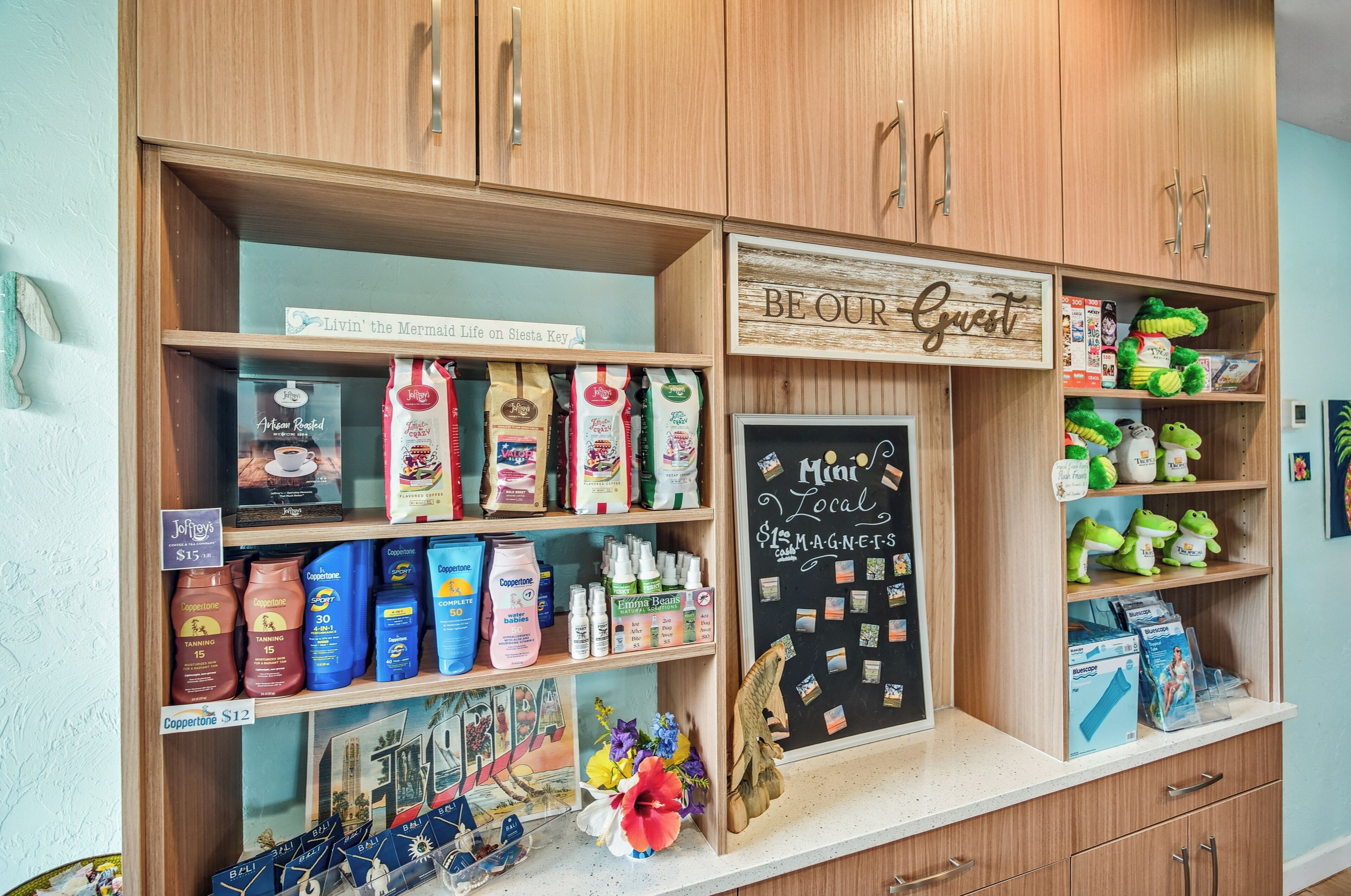 A store with wooden shelves stocked with various products, including coffee, tea, and snacks.