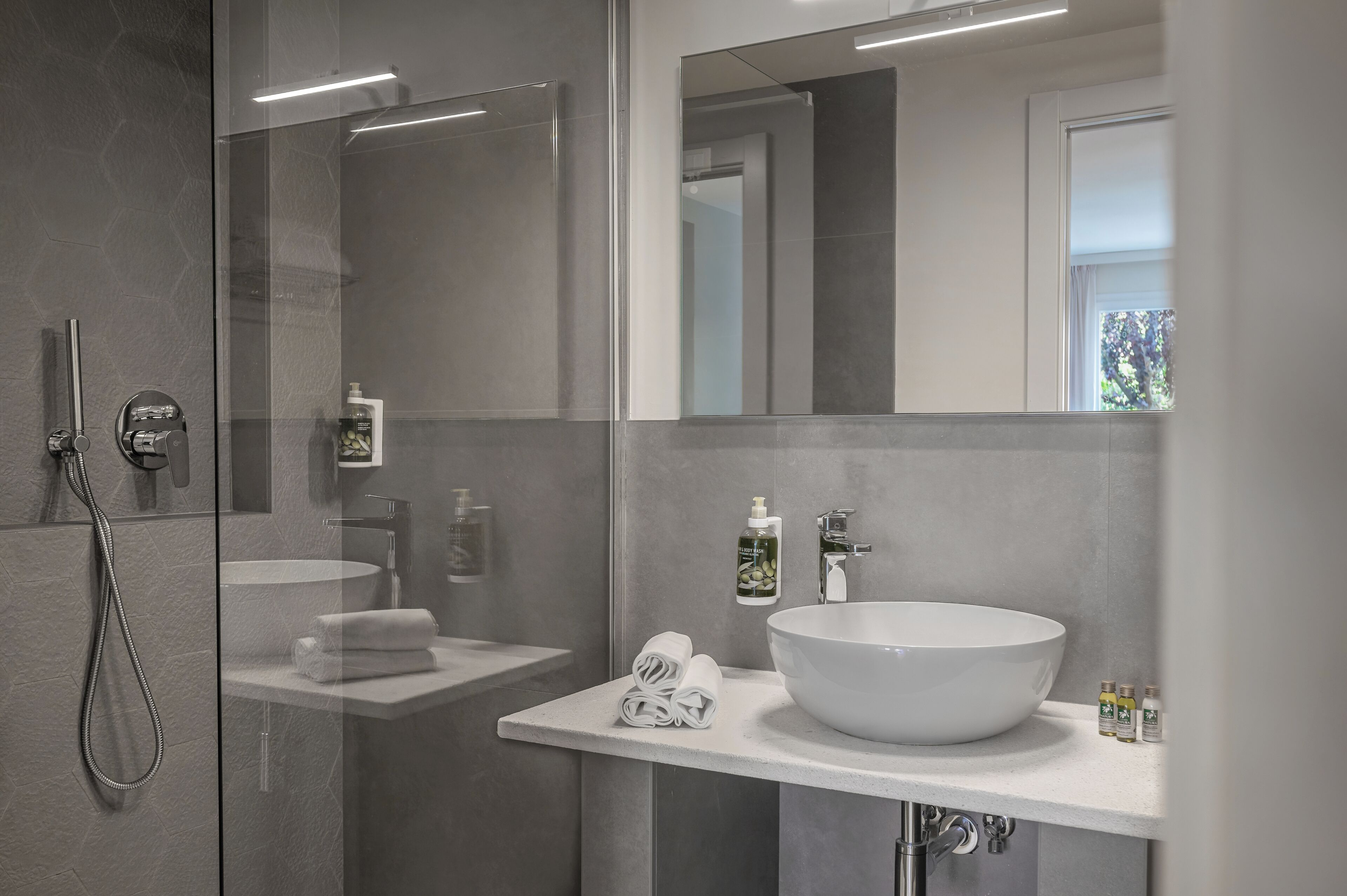 deluxe triple room | bathroom | eco-friendly toiletries, hair dryer, bidet, towels