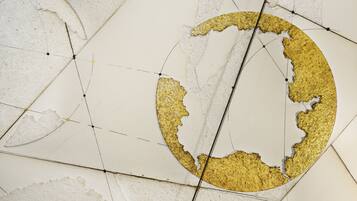 A geometric pattern with gold accents on a white background.