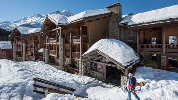 Guests can enjoy a traditional chalet-style building with multiple balconies and a covered entrance.