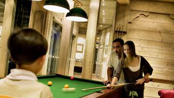 Relax and unwind in our recreational area, featuring a pool table and comfortable seating.