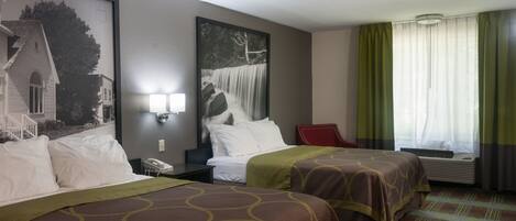 A hotel room with two beds, a nightstand, a red chair, a window with curtains, and a wall-mounted phone.
