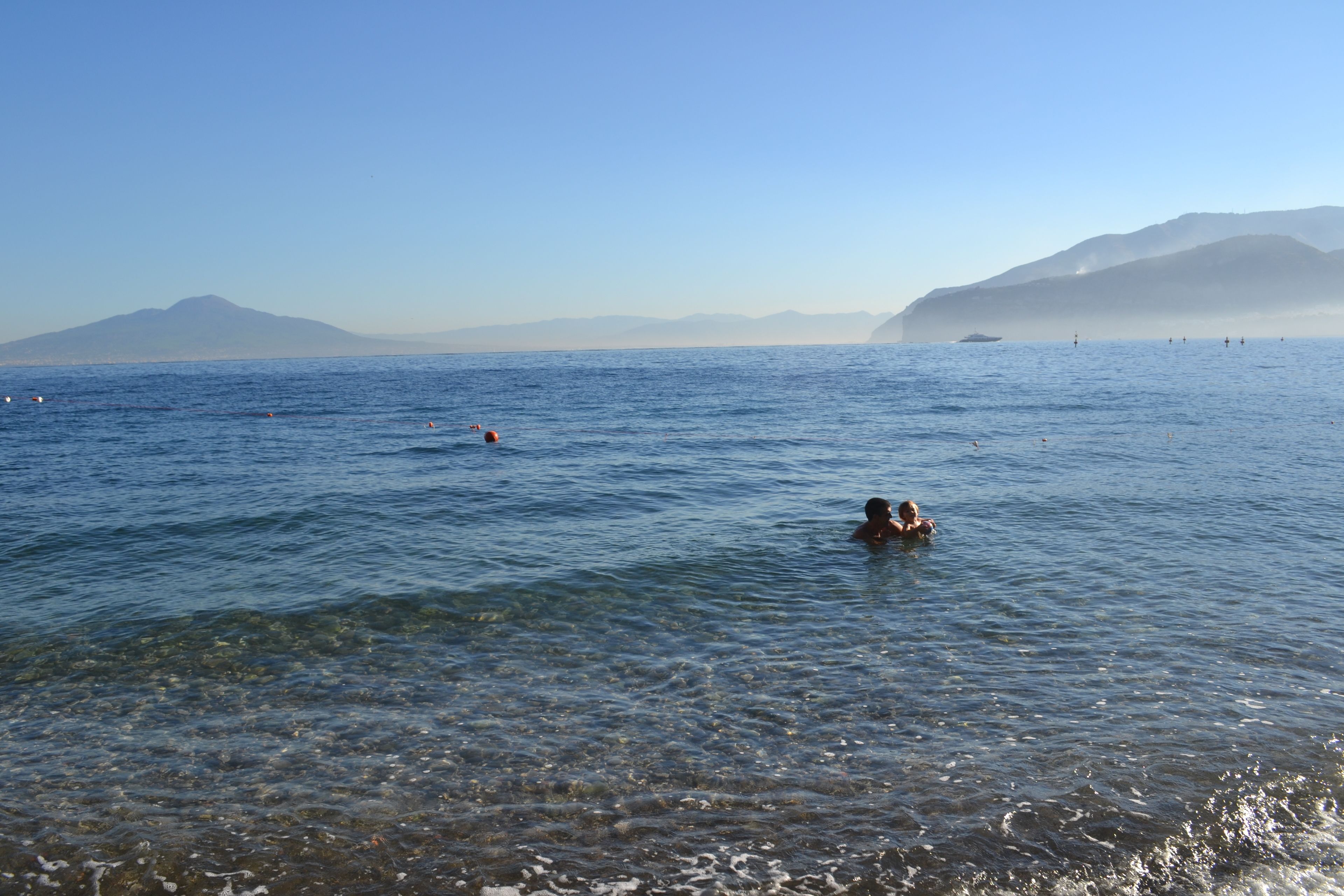 private beach, black sand, sun-loungers, beach umbrellas