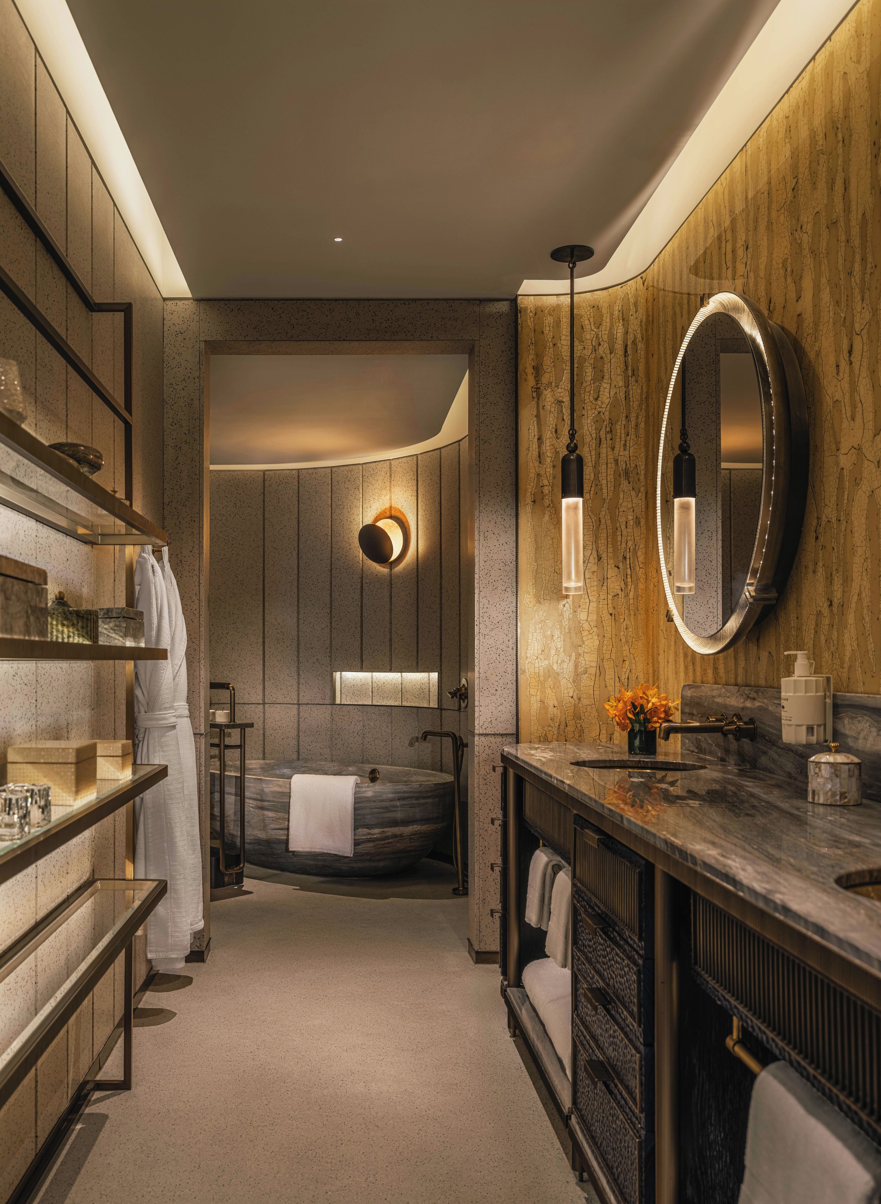 A modern bathroom with a freestanding bathtub, a vanity with a mirror, and a towel rack.