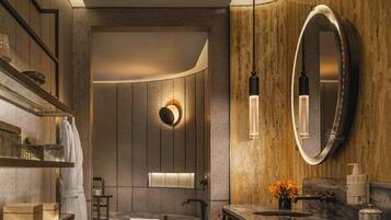A modern bathroom with a freestanding bathtub, a vanity with a mirror, and a towel rack.