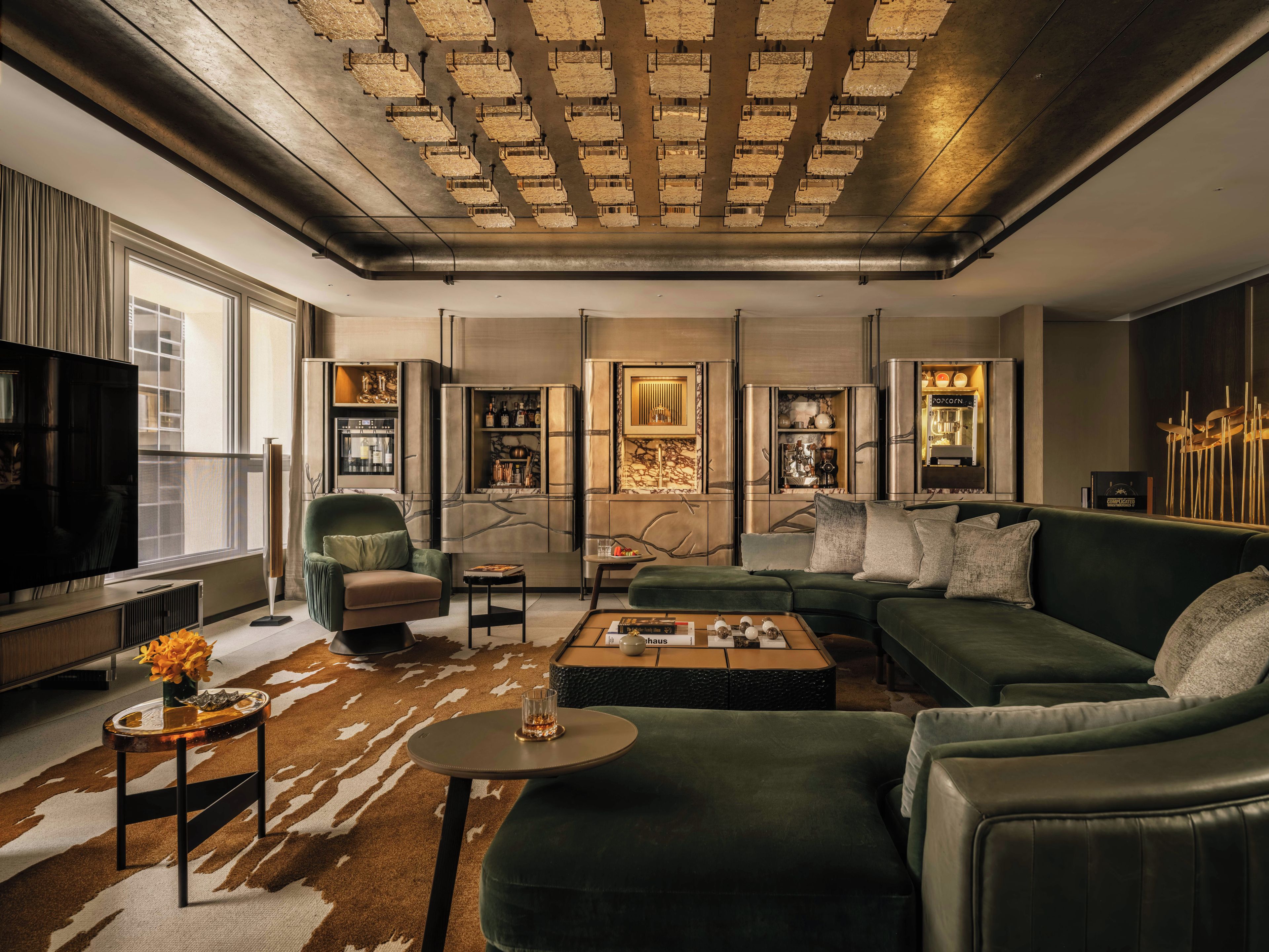 A modern living room with a sectional sofa, a flat-screen TV, and a coffee table.