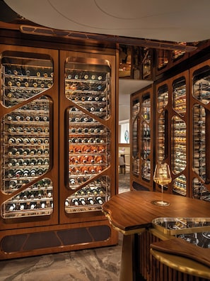 A wine cellar with multiple wine racks and a bar area. - Mandarin Oriental The Landmark, Hong Kong (Hong Kong)