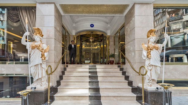 A grand entrance with marble steps, golden statues, and a sign reading "GLORIOUS". - Glorious Hotel (Istanbul)