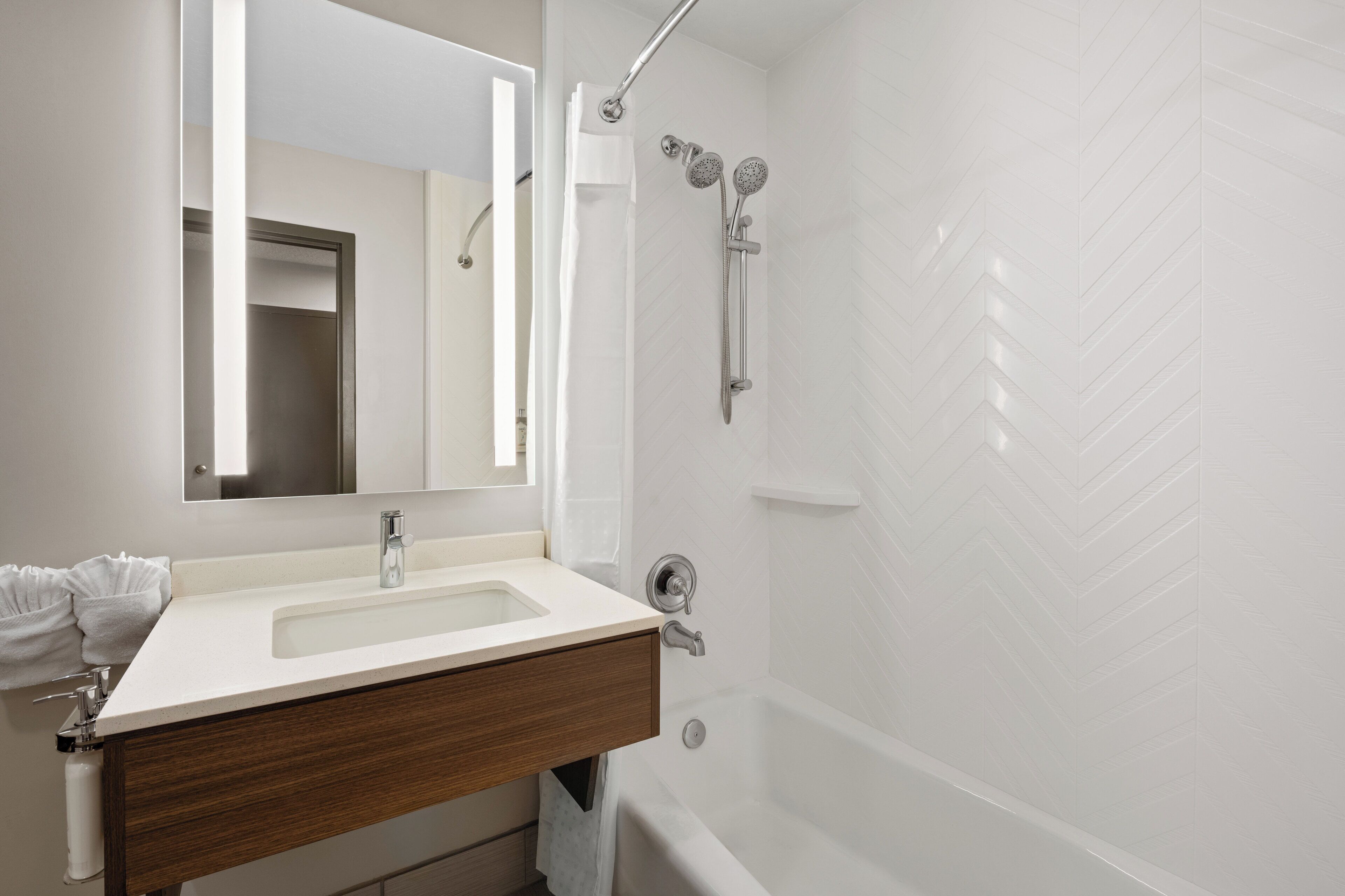 combined shower/bathtub, designer toiletries, hair dryer, towels