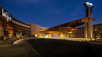 A large hotel with a prominent tower and a curved driveway leading to the entrance.