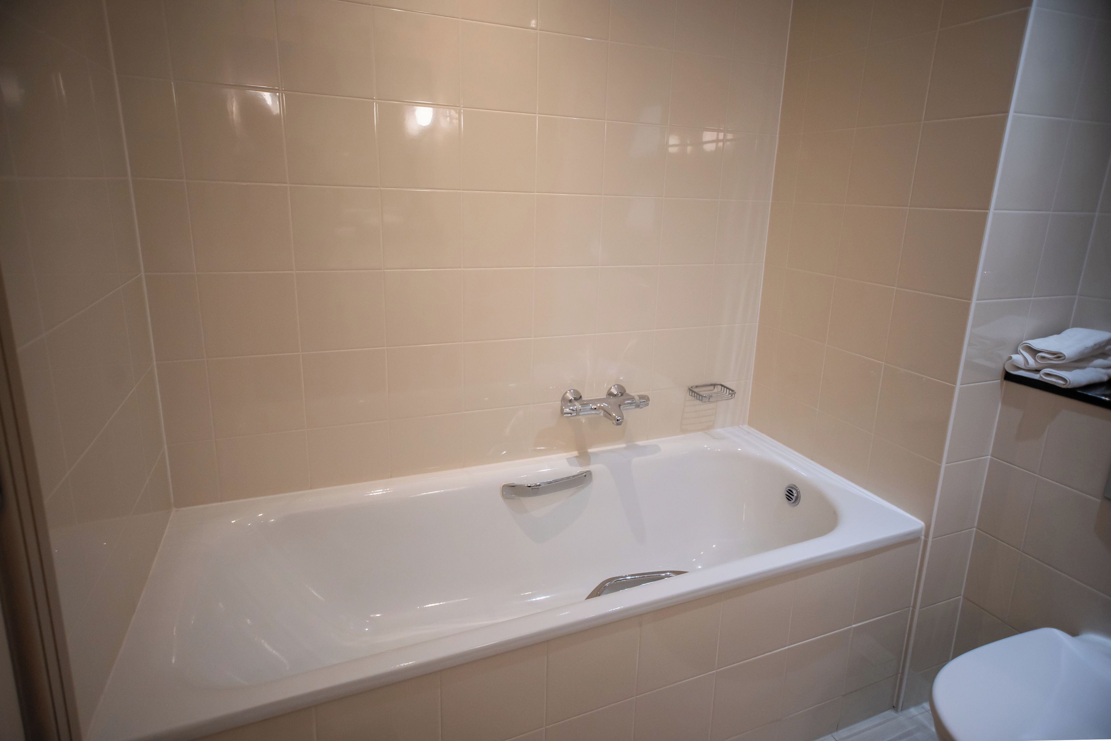 A bathroom with a bathtub, a toilet, and a sink.