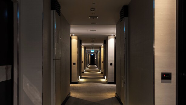 A long, well-lit hallway with doors on both sides, leading to a central exit. - Crowne Plaza Belgrade by IHG (Belgrade)