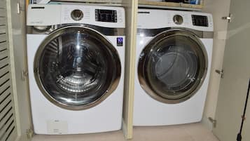A compact, white front-loading washer and dryer unit with a control panel and a 10-year warranty sticker.