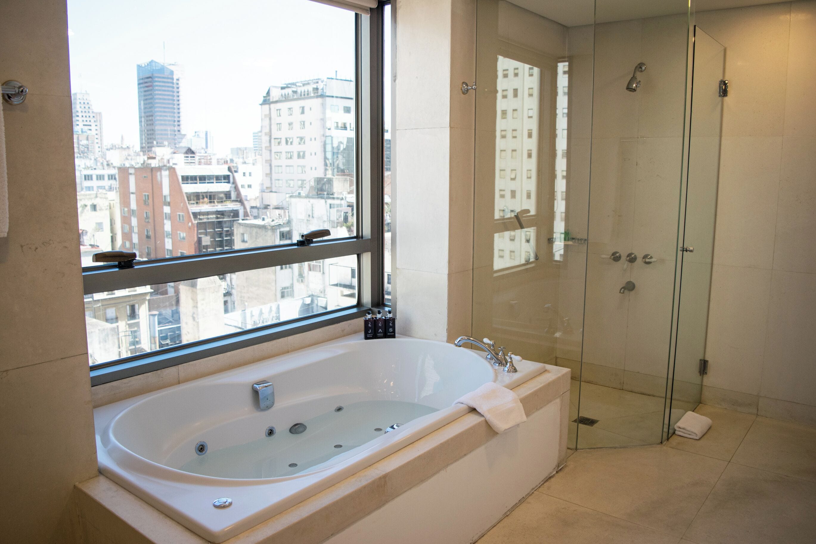 master suite | bathroom | deep-soaking bathtub, rainfall showerhead, free toiletries, hair dryer