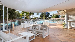 A rooftop pool area with white outdoor furniture, including sofas and chairs, and a covered seating area. - THB Tropical Island Aparthotel (Yaiza)