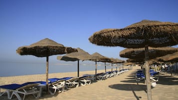 Private beach, white sand, sun loungers, beach umbrellas