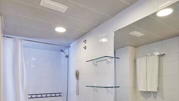 A modern bathroom with a bathtub, toilet, and sink.