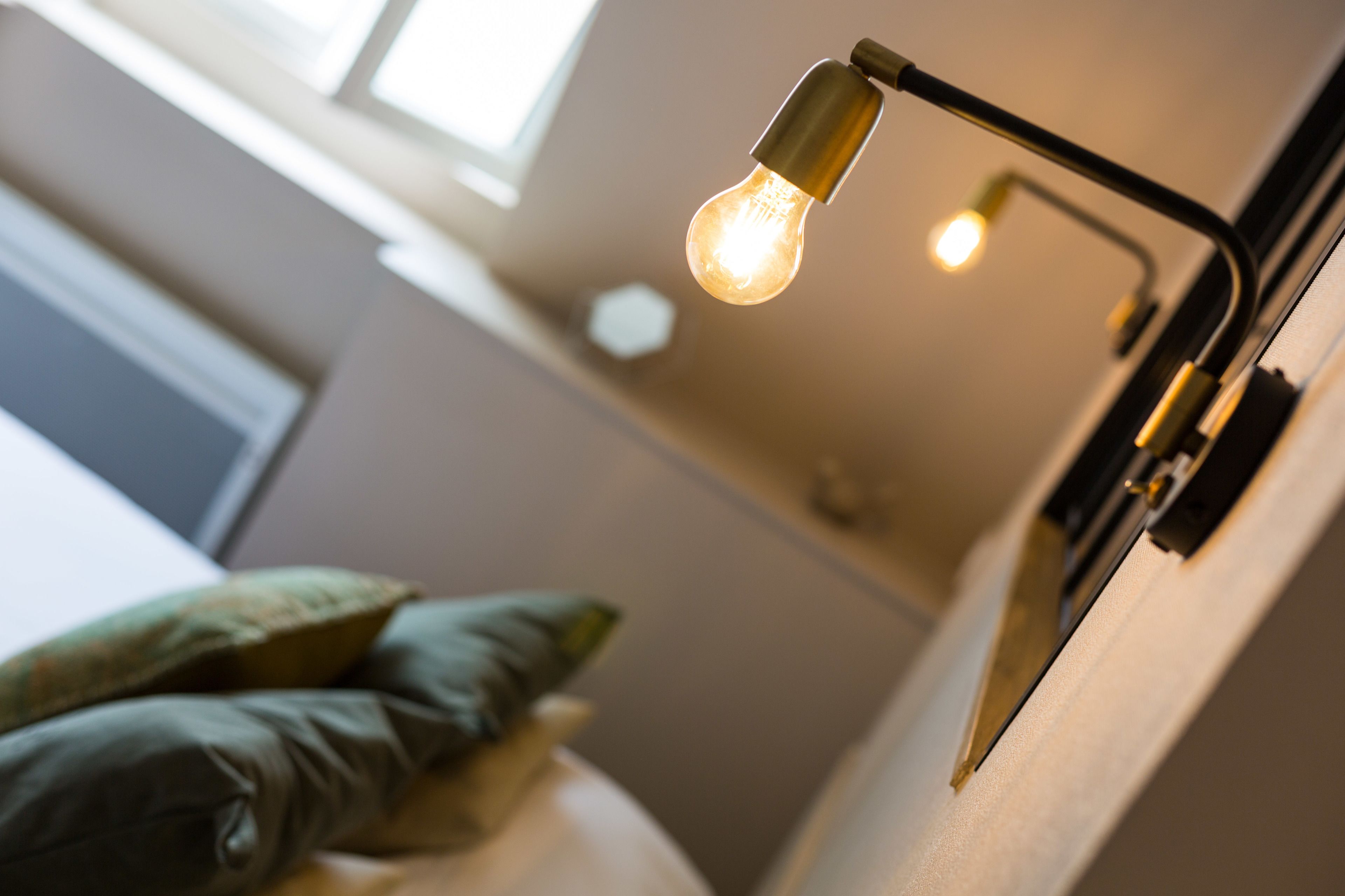 A close-up of a light fixture with a visible bulb and a metallic frame.