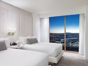 A modern lounge area with a fireplace, seating, and a bar. at W Las Vegas