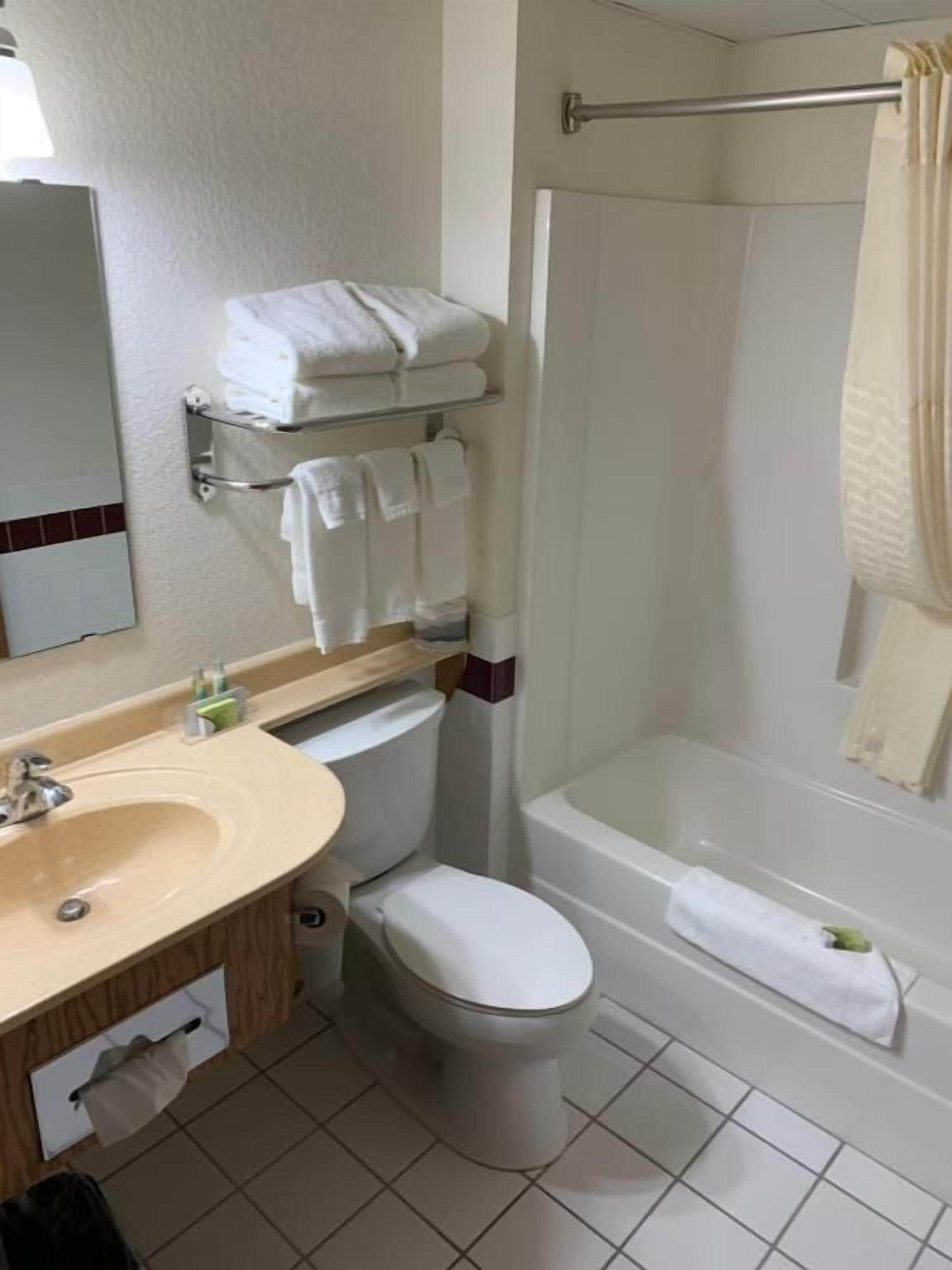 A bathroom with a sink, toilet, and bathtub.