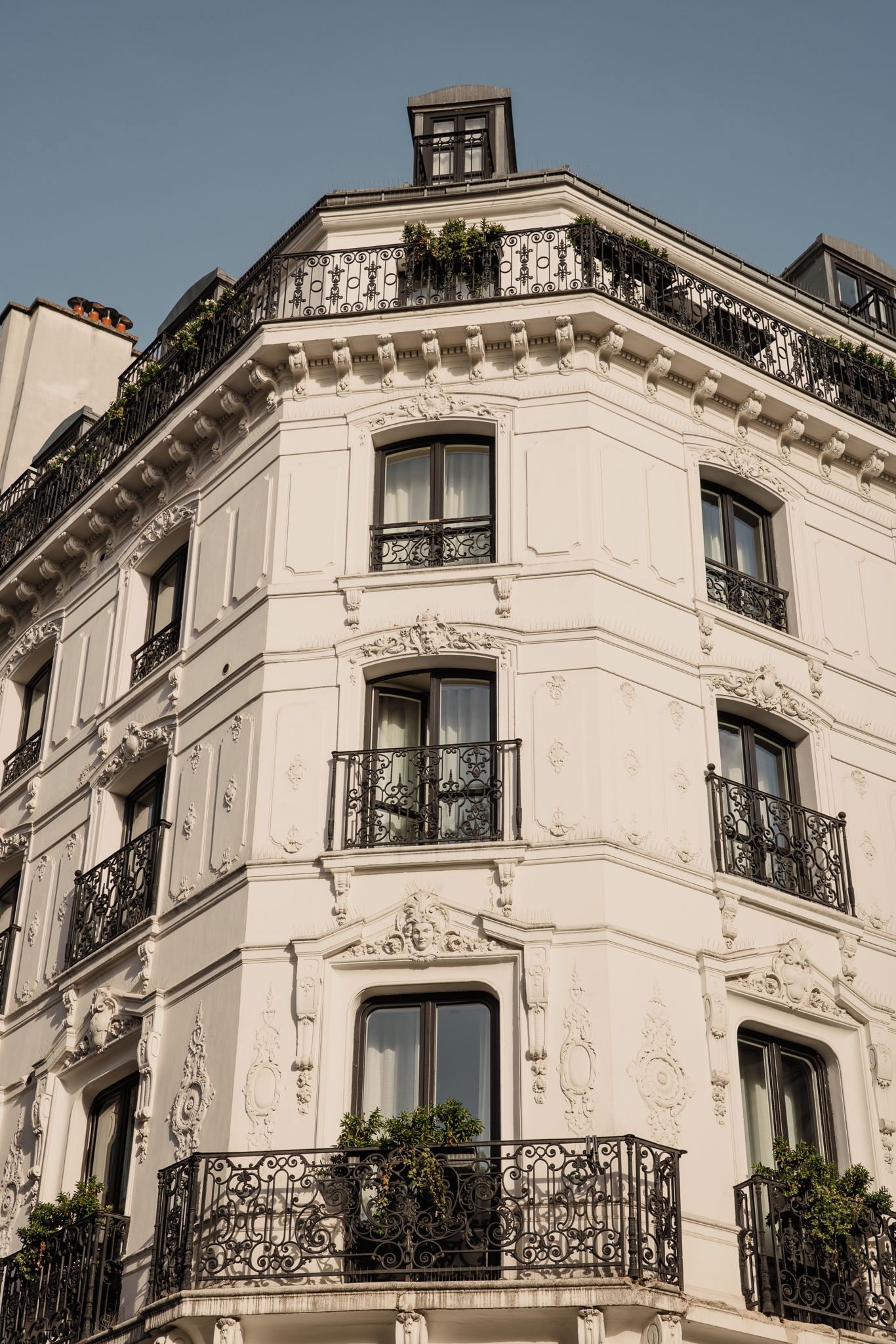 A multi-story building with ornate balconies and decorative moldings.