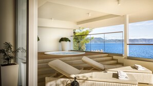 A modern balcony with a hot tub, wicker furniture, and a scenic ocean view. - Girandella Resort, Valamar Collection (Labin)