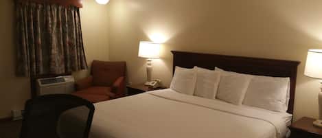 Premium bedding, desk, laptop workspace, blackout drapes