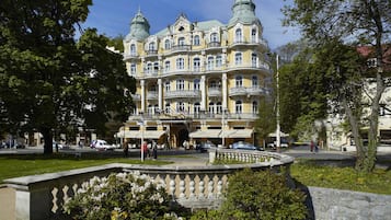 A historic building with ornate architecture, multiple balconies, and a central courtyard.