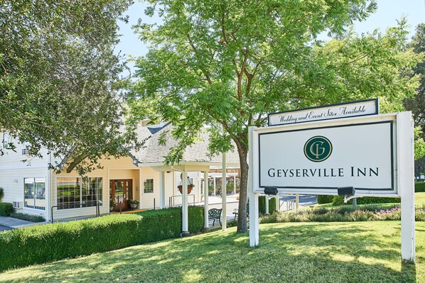 A sign for Geyserville Inn with a logo, indicating wedding and event site availability.