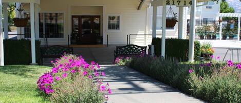 A building with a porch, a number '21714' above the entrance, and a pathway leading to the door.