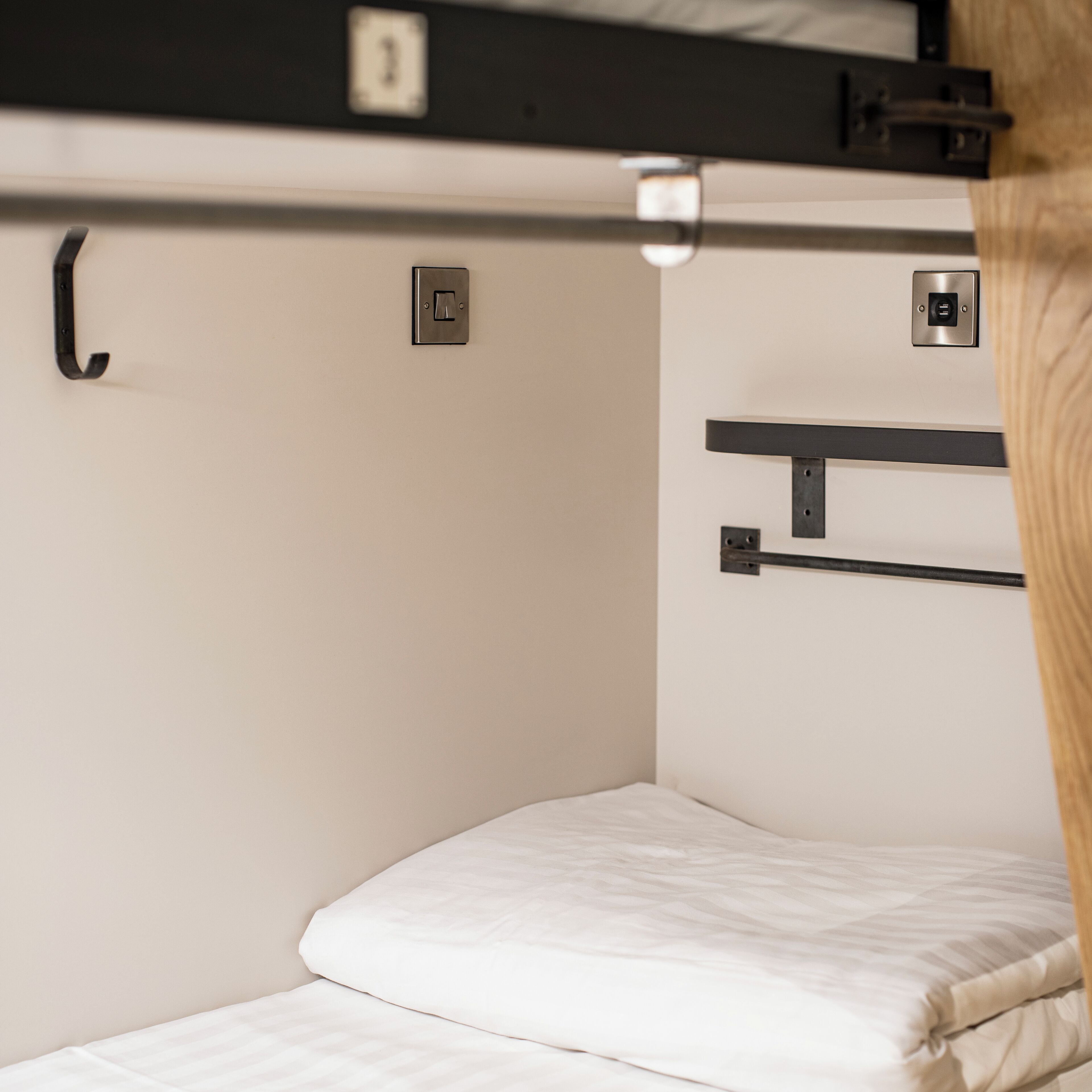 A bunk bed with a pull-out desk and a small shelf.